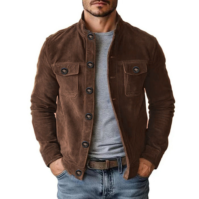 Man wearing a brown corduroy jacket over a gray shirt on a white background