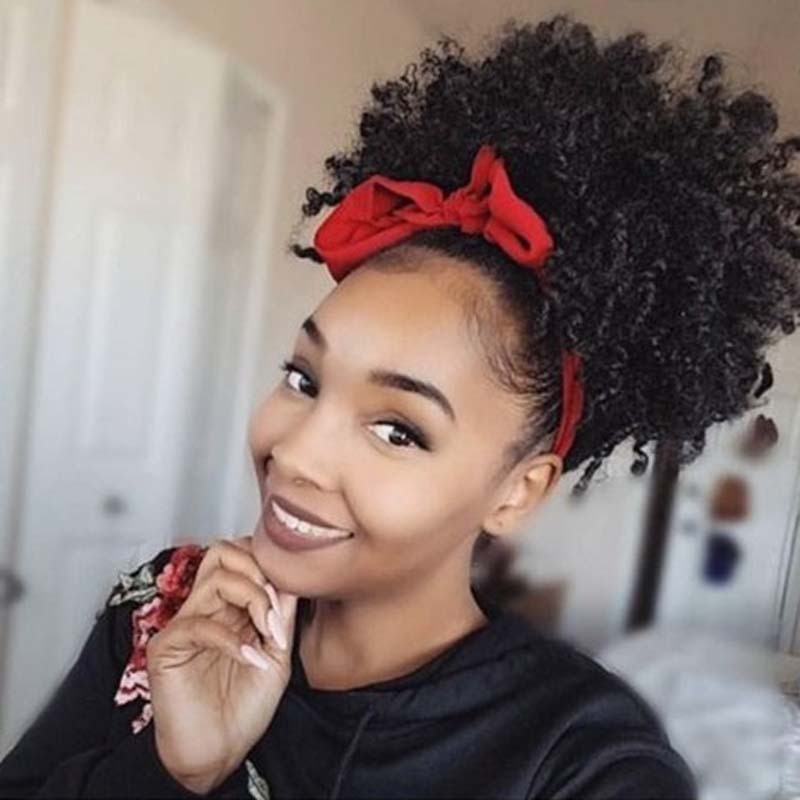 Woman with styled hair wearing a red headband indoors