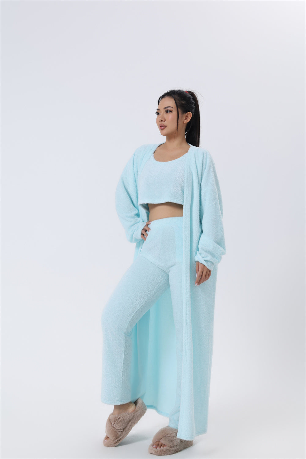 Woman wearing a light blue outfit on a white background