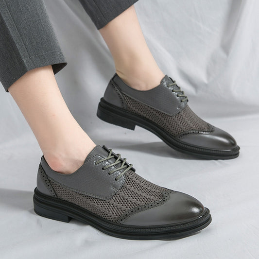Gray dress shoes worn with gray pants on a light gray background