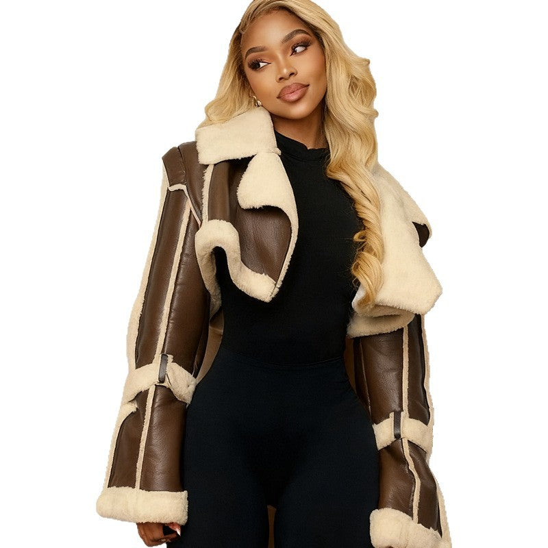 Woman wearing a brown and beige shearling coat on a white background