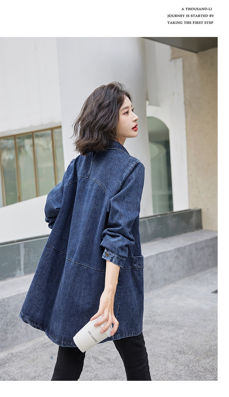 Woman wearing a blue denim jacket in an urban setting