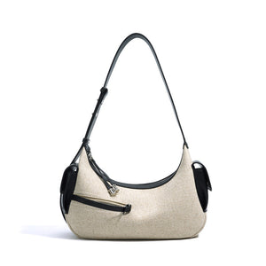 Beige handbag with black accents on a white background
