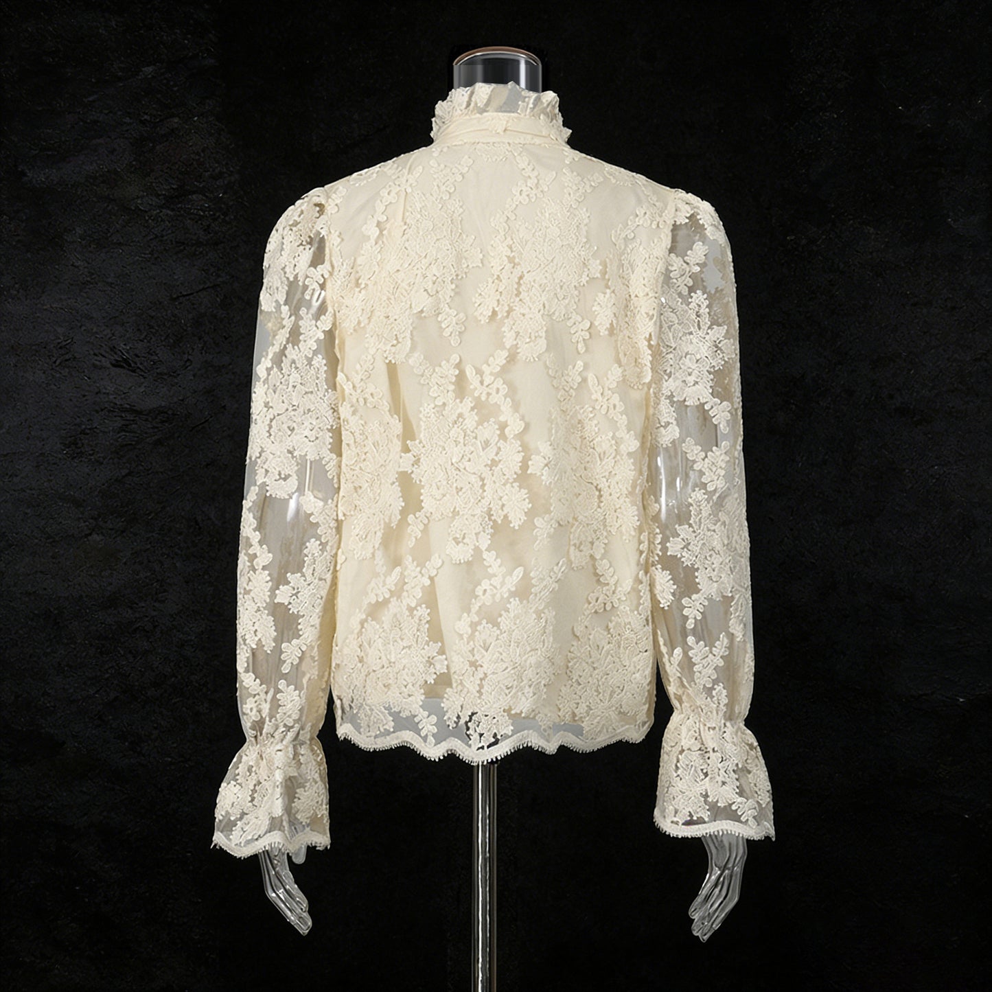 White lace blouse on a mannequin against a black background