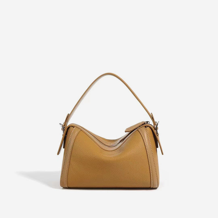 Tan handbag on a light gray background