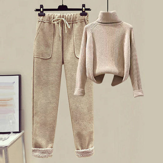 Beige sweater and jogger pants set on a hanger against a plain background