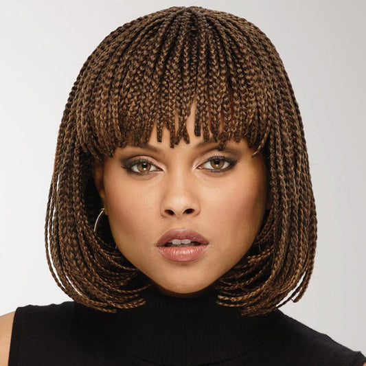 Woman with braided hairstyle wearing a black top against a plain background