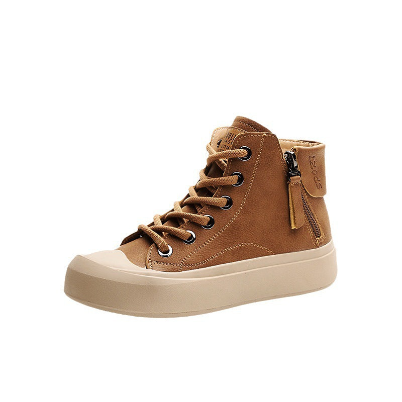 A single mid-top lace-up sneaker in brown suede with a beige rubber toe cap and sole, featuring a side zipper with a pull tab.