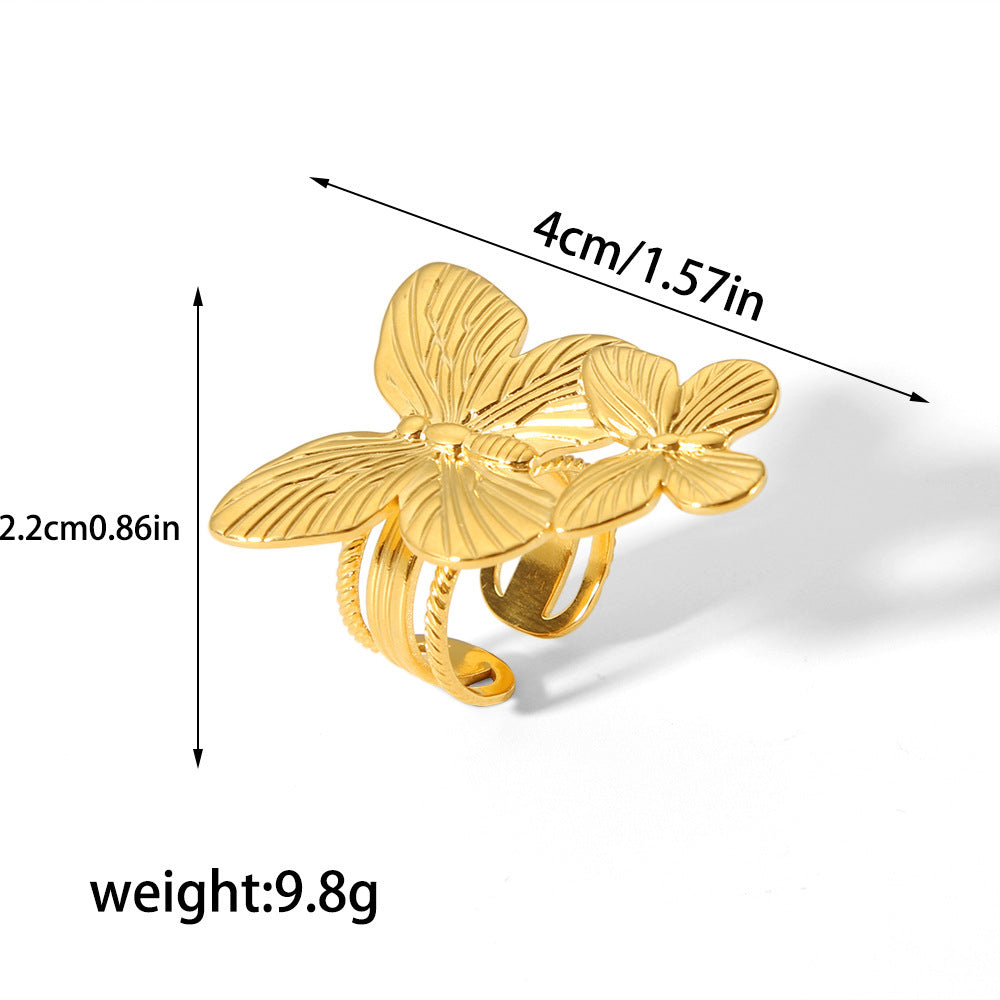Gold butterfly ring with measurements and weight on a white background