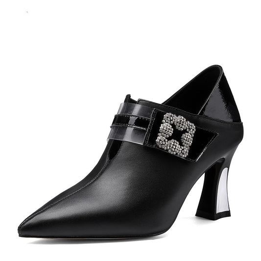 Black high-heeled shoe with a decorative buckle on a white background