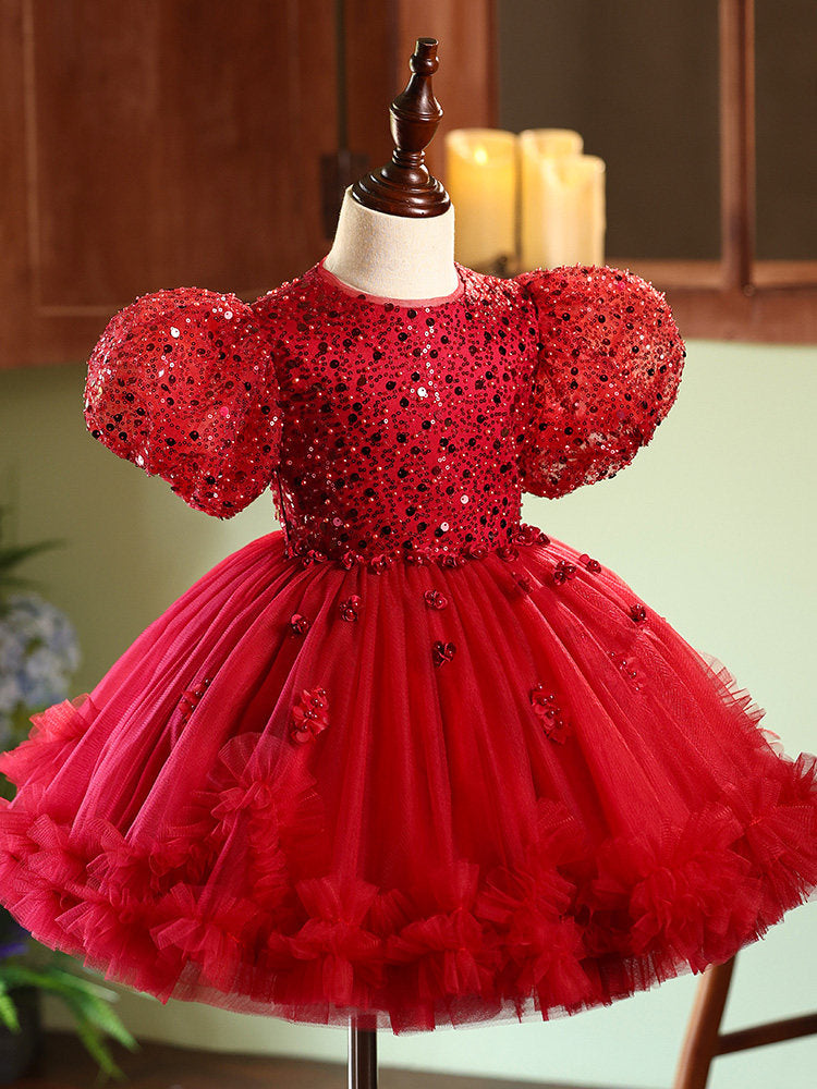 Red sequin dress on a mannequin with a blurred background