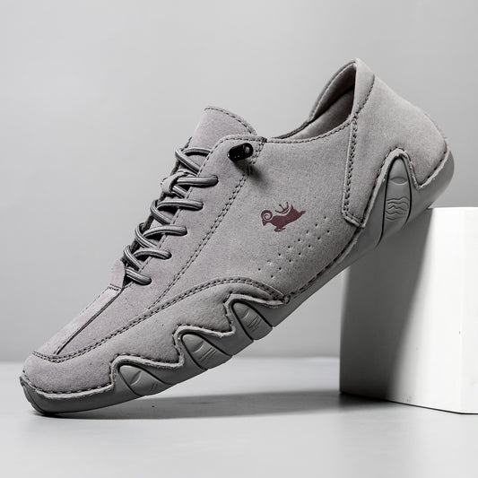 Gray sneaker with a brand logo on a light gray background