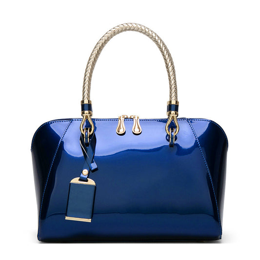 Blue handbag with gold accents on a white background