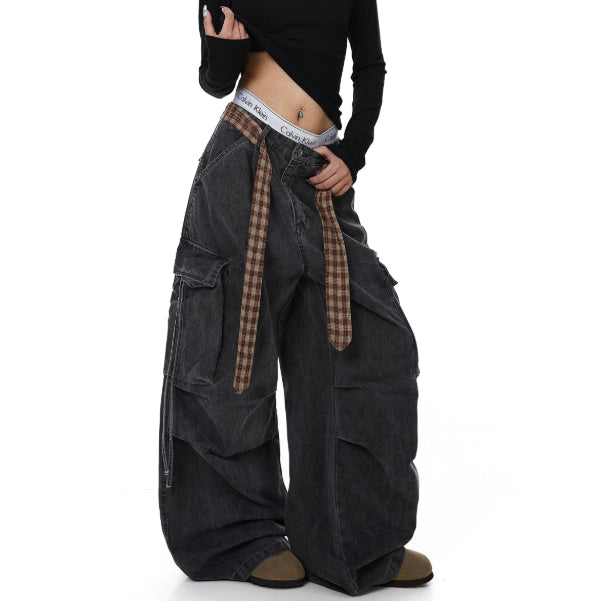 Dark gray wide-leg pants with a plaid belt on a white background