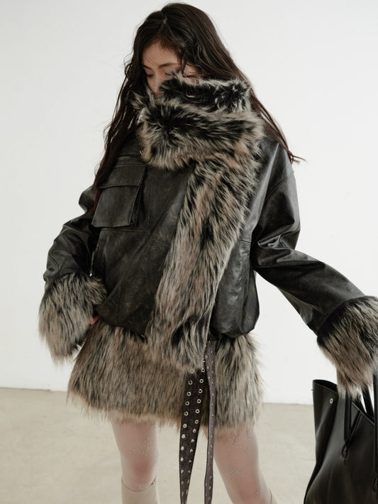 Person wearing a dark coat with fur trim against a white background