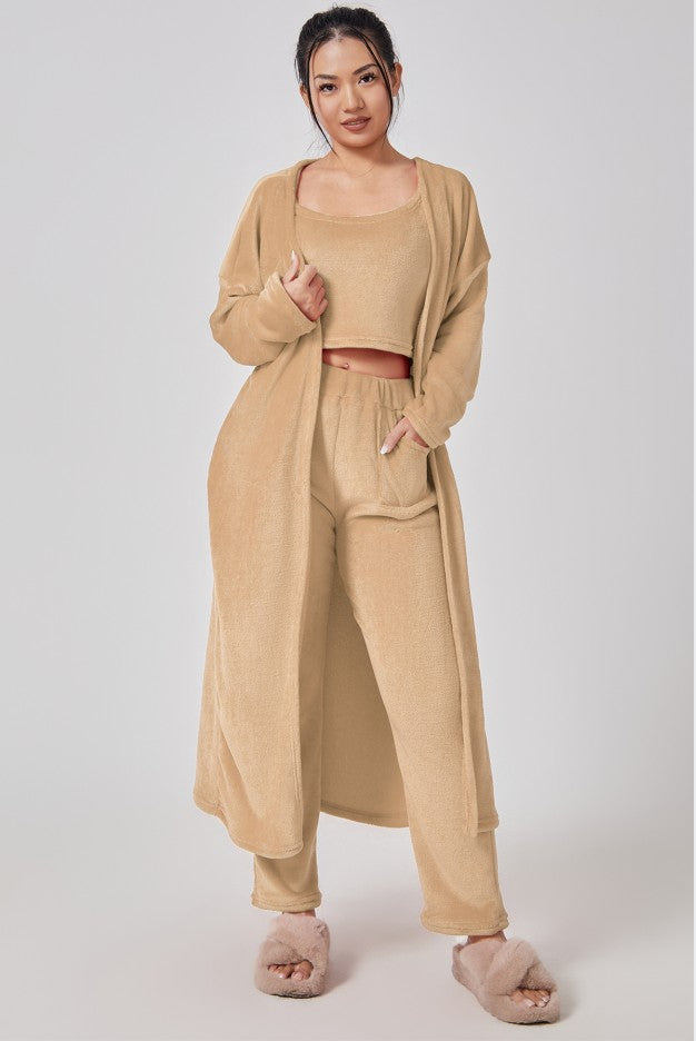 Woman wearing a beige outfit with a matching cardigan on a white background
