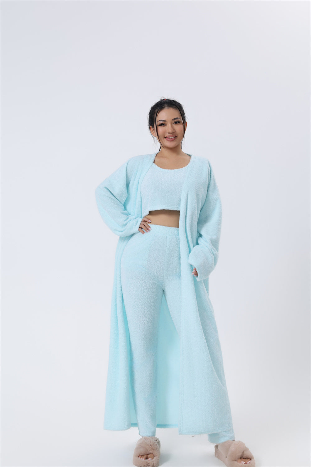 Woman wearing a light blue outfit on a white background