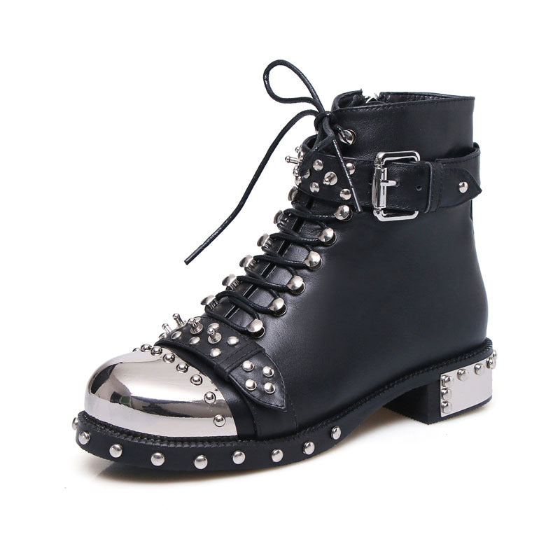 Black leather boot with silver studs and metallic sole on a white background