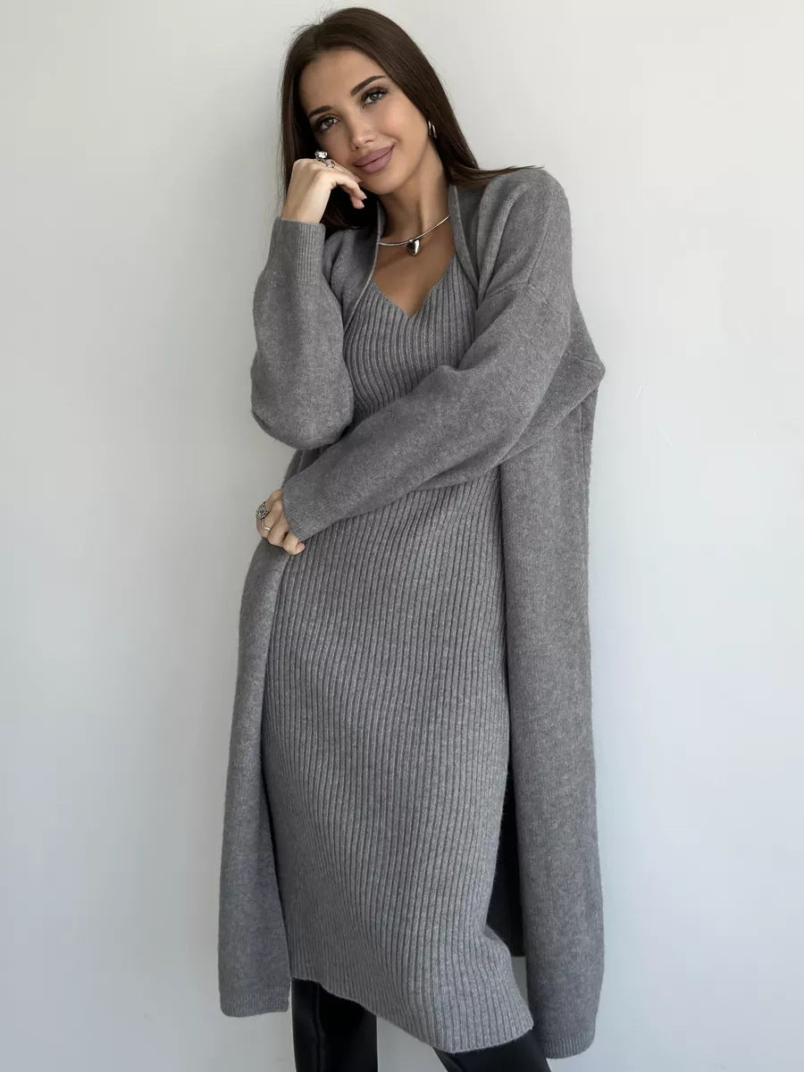 Woman wearing a long gray sweater against a white background