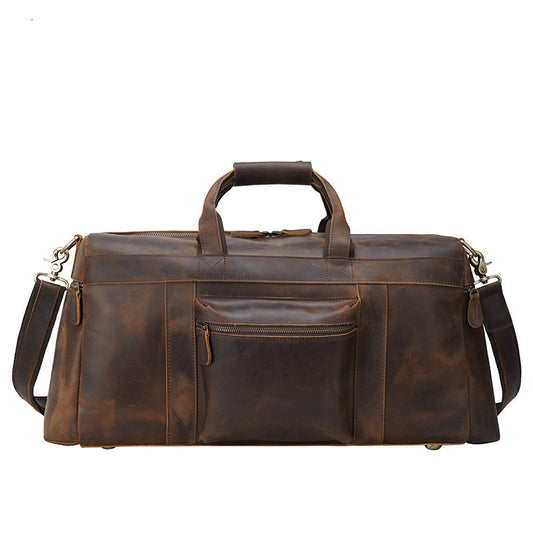 Brown leather duffel bag with multiple pockets on a white background