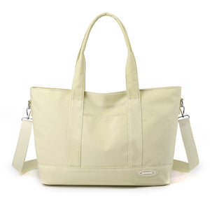 Light green tote bag with shoulder strap on a white background