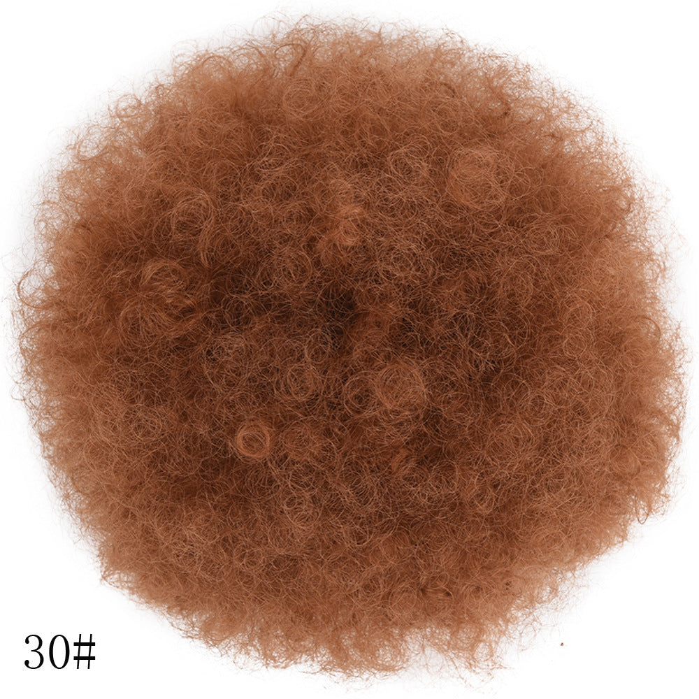 Clump of brown hair extensions on a white background
