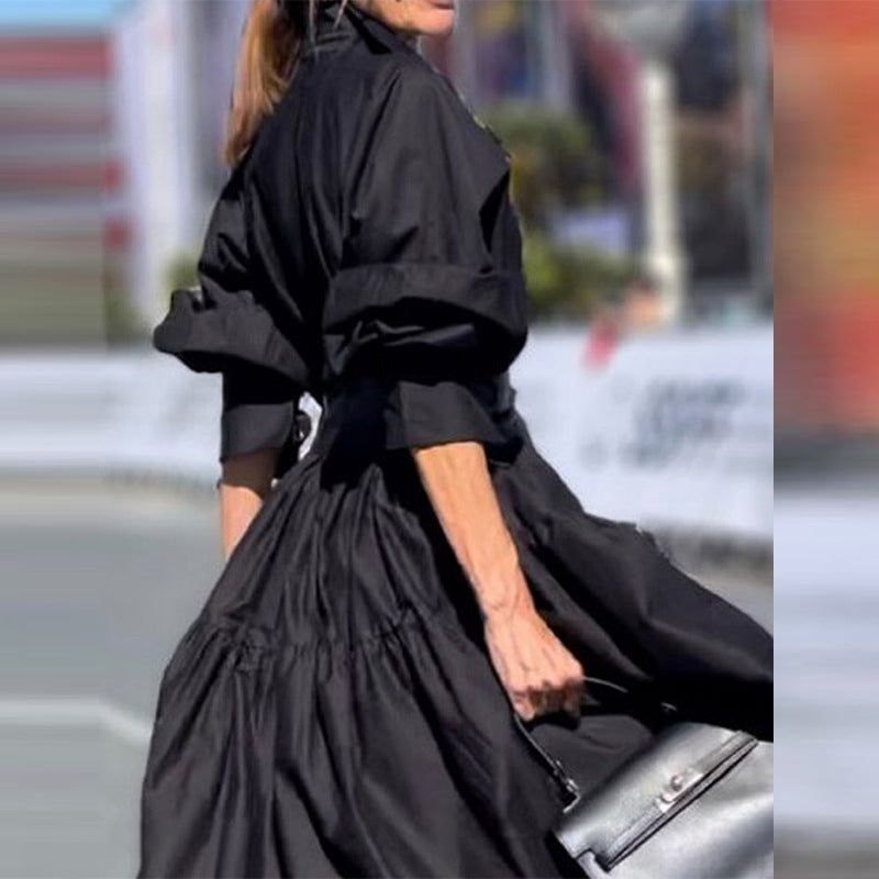 Person wearing a black dress with a blurred background