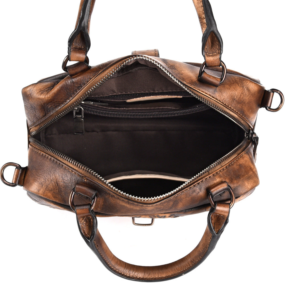 Brown leather duffel bag with open top on a white background