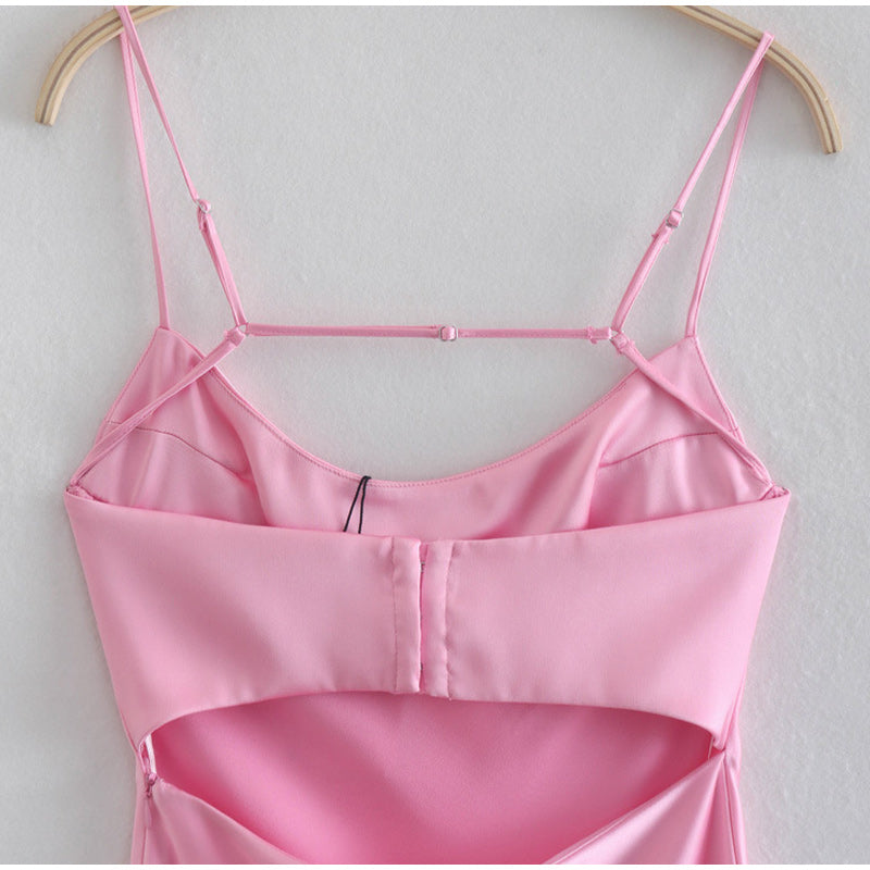 Pink satin camisole on a hanger against a light gray background by millivan