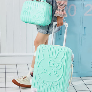Person holding a mint green suitcase with a Hello Kitty design in front of blue lockers.