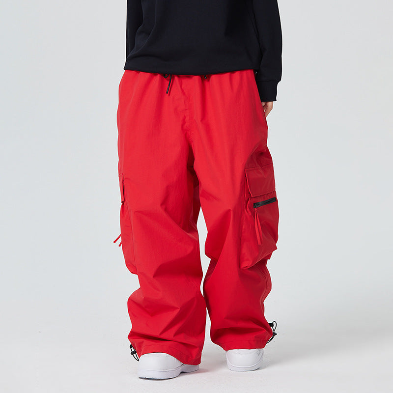 Red cargo pants worn by a person on a white background