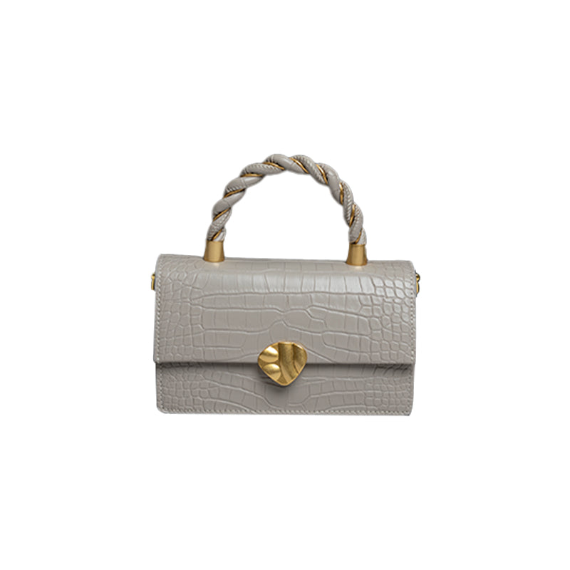 Gray handbag with gold accents on a white background