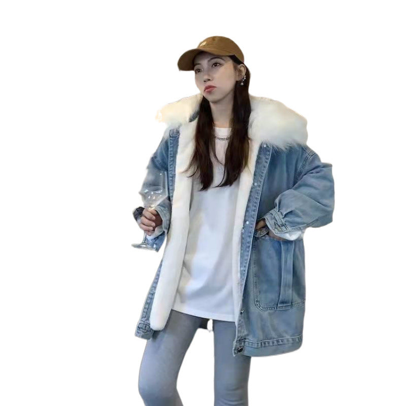 Person wearing a denim jacket with white fur lining, holding a glass, on a white background