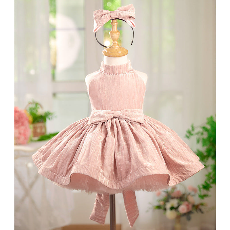 Pink dress on a mannequin with a blurred floral background