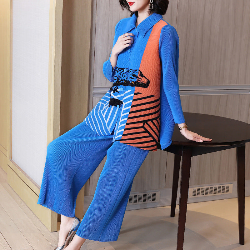 Woman in a blue and orange outfit sitting on a table indoors.