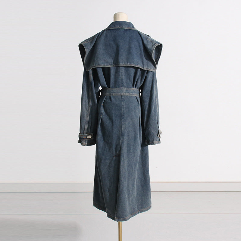 Denim trench coat on a mannequin against a white background