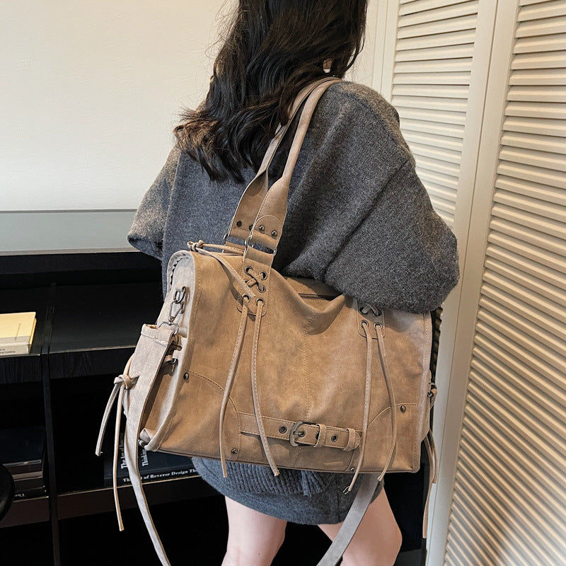 Person wearing a brown leather backpack indoors