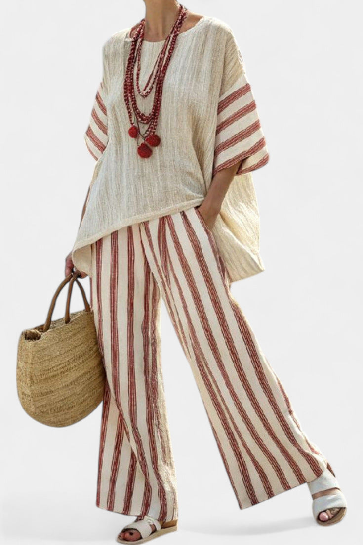 Person wearing a white and red striped outfit with a straw bag on a white background