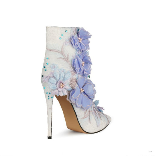 High-heeled shoe with floral design on a white background