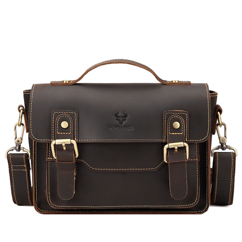 Brown leather satchel bag with shoulder straps on a white background