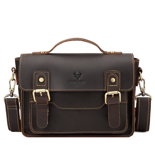 Brown leather satchel bag with shoulder straps on a white background