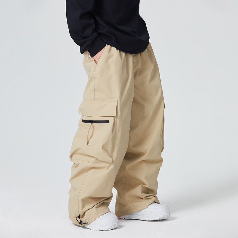 Person wearing beige cargo pants and white sneakers on a plain background