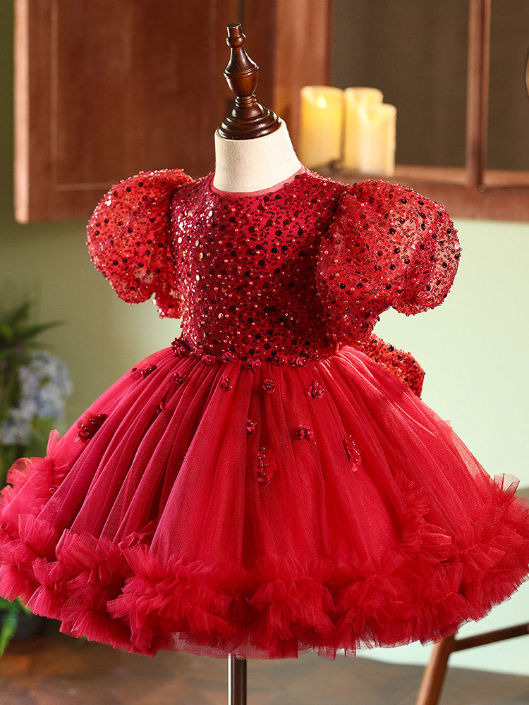 Red sequin dress on a mannequin with a blurred background