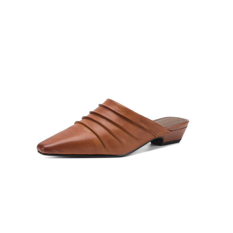 Brown leather mule shoe on a white background