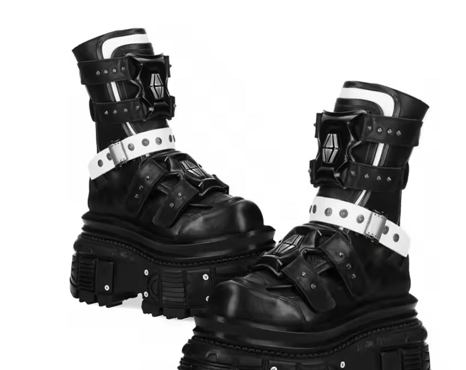 Pair of black boots with metallic accents on a white background