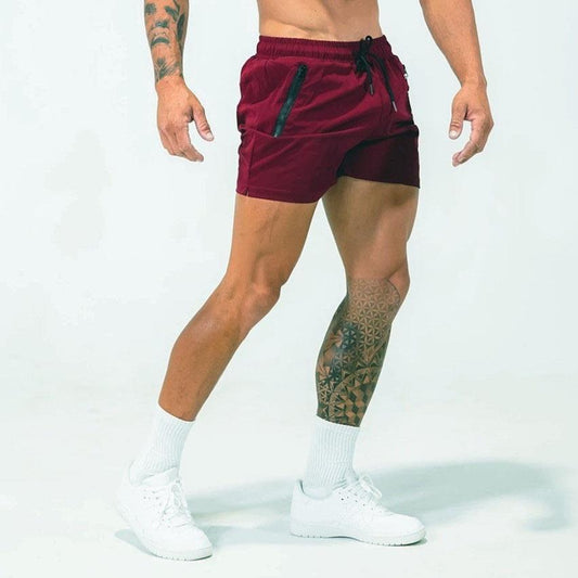 Person wearing maroon athletic shorts on a white background
