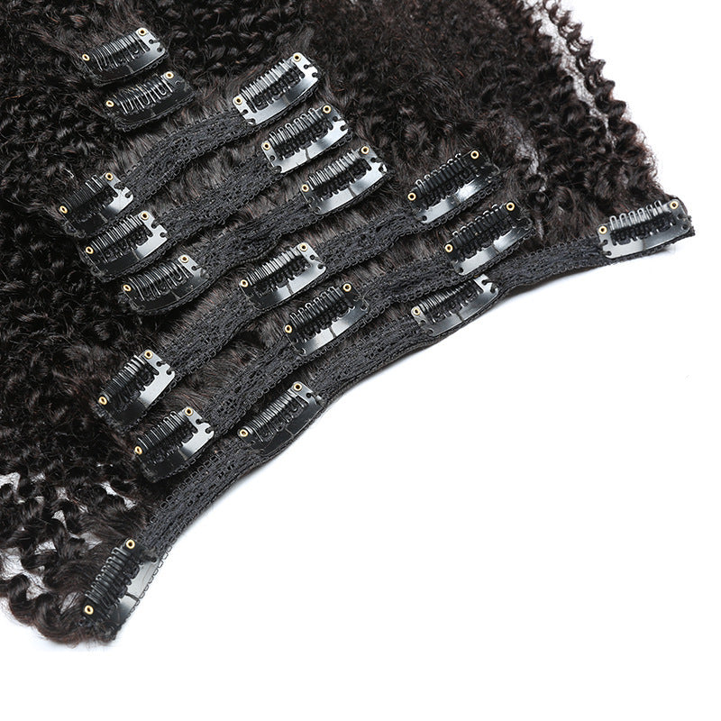 Black hair extensions with clips on a white background
