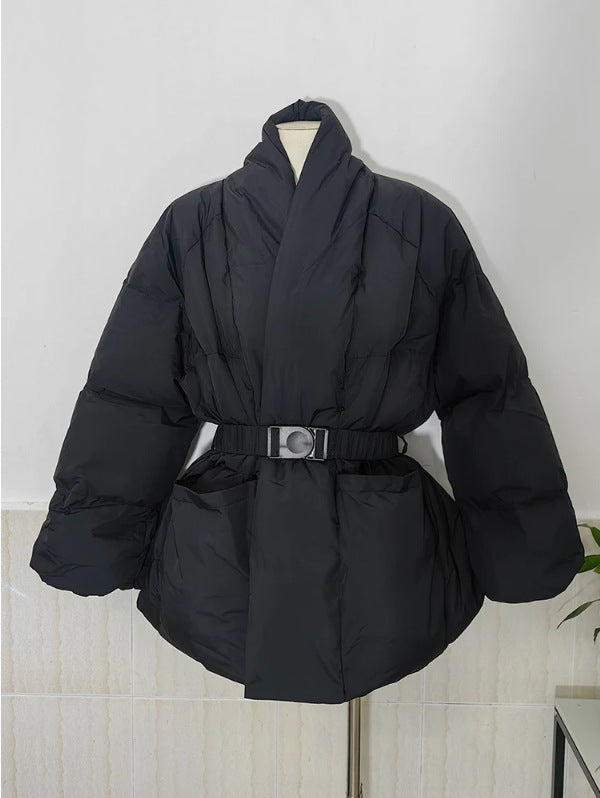 Black puffer coat with a belt on a mannequin against a white wall.