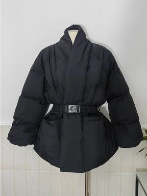 Black puffer coat with a belt on a mannequin against a white wall.