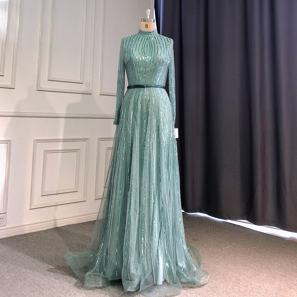 Green evening gown on a mannequin against a neutral background